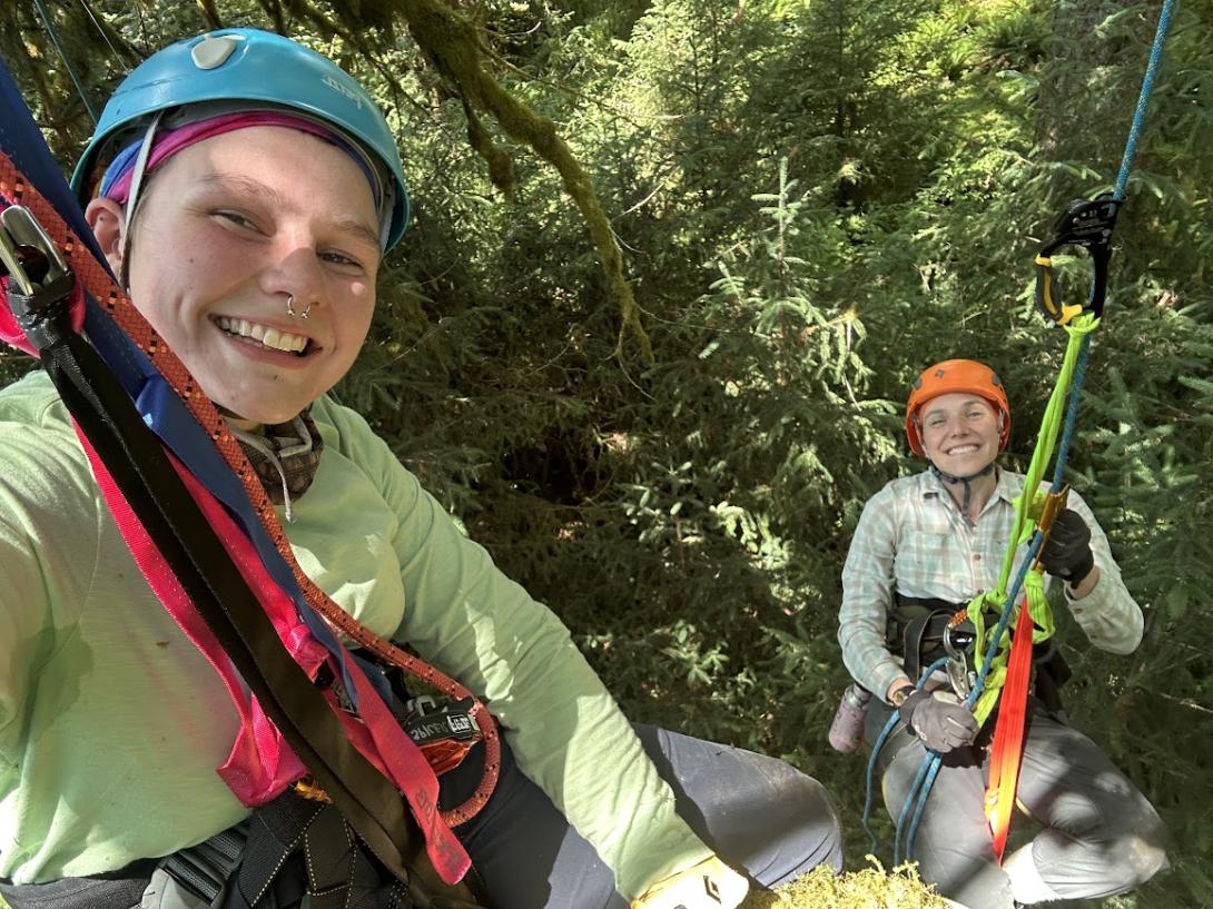 Kyla Richards takes a selfie with Michelle Spicer as they climb a tree for research.